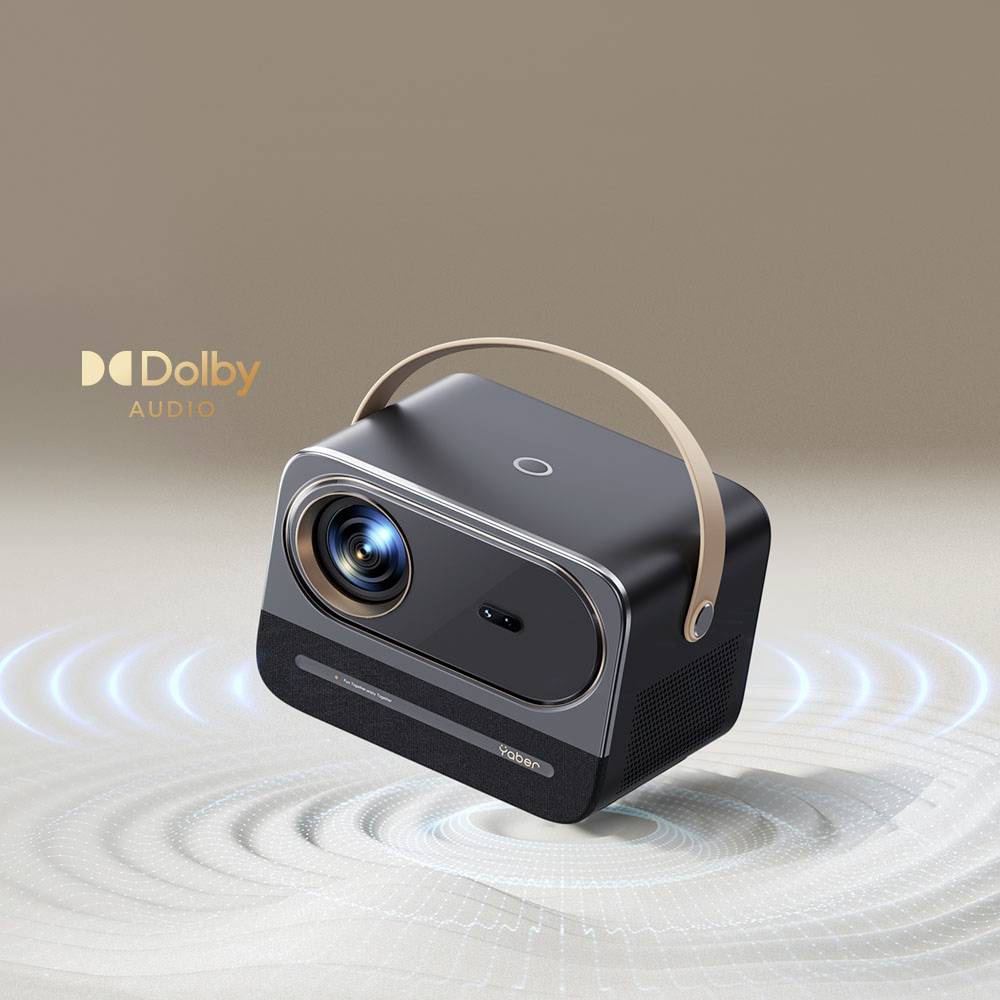 Een draagbare projector met ingebouwde Dolby-audio, toont luidsprekergolven. Donkergrijs behuizing met een lichte handgreep.