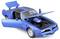 Blauwe auto met geopende deuren en motorkap, toont motor en details van het interieur. Modelauto op neutrale achtergrond.