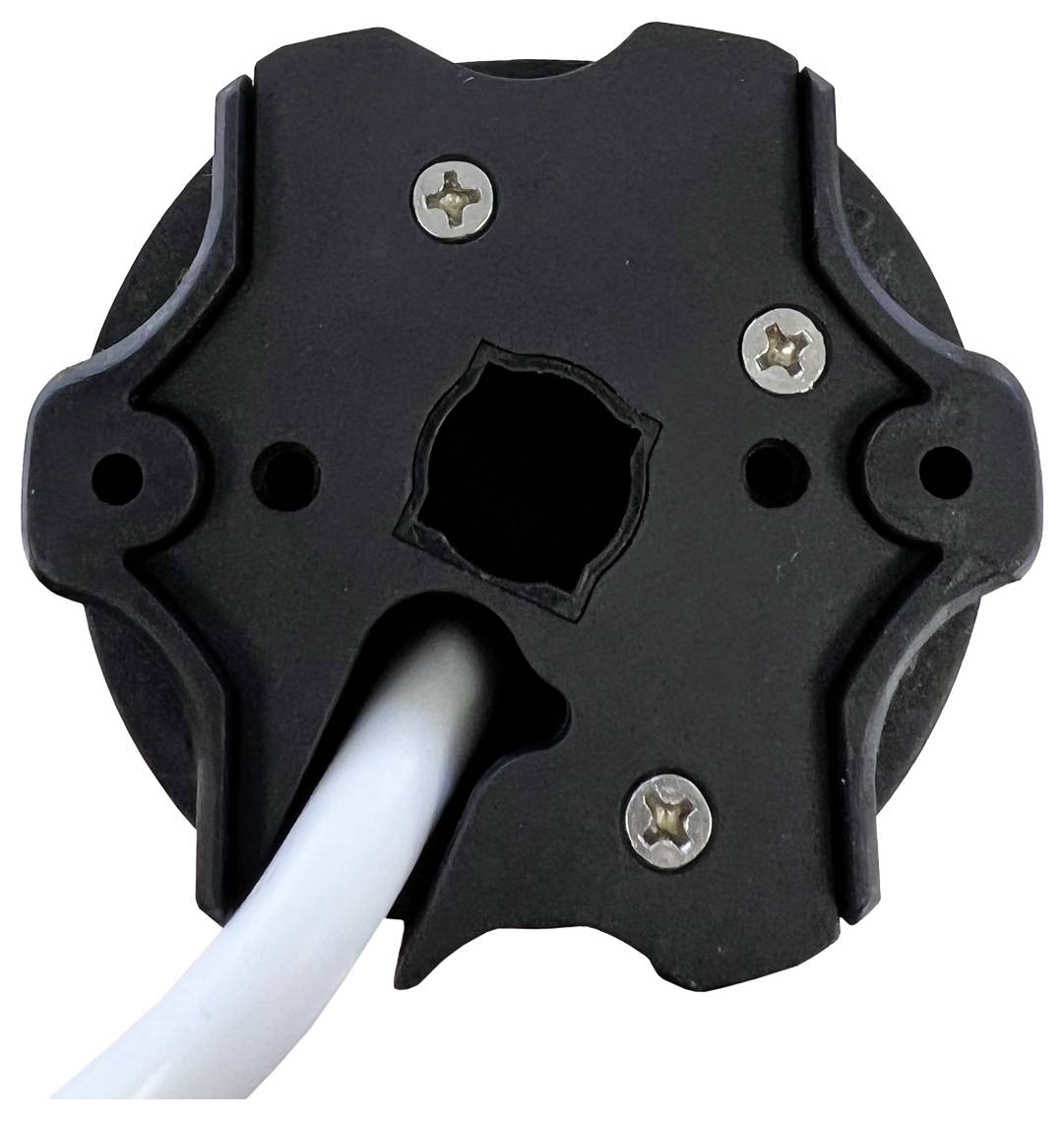 Zwart, rond elektrisch onderdeel met vier schroeven en kabelinvoer, twee gaten aan elke zijde van een centrale opening.