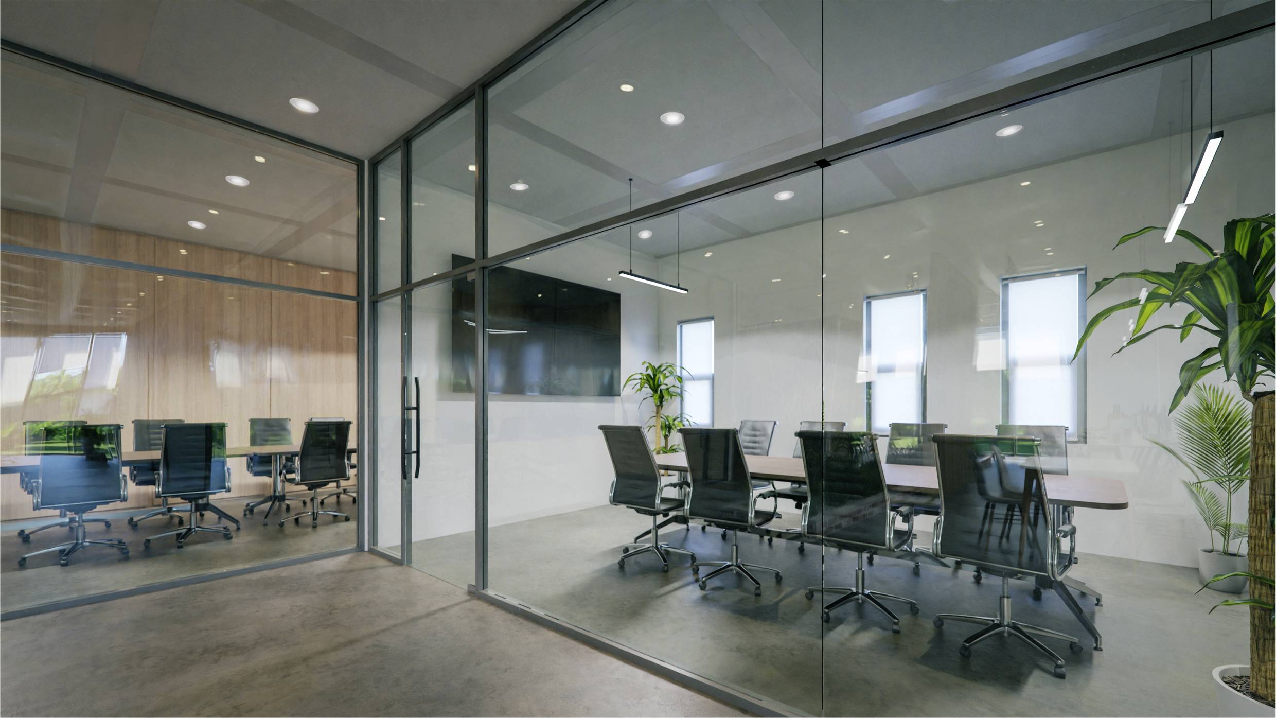 Vergaderruimte met glazen wanden, een lege vergadertafel met zwarte stoelen. Planten en delfinvormige decoratieve verlichting completeren het moderne design. Links nog een kantoor met bureaus.