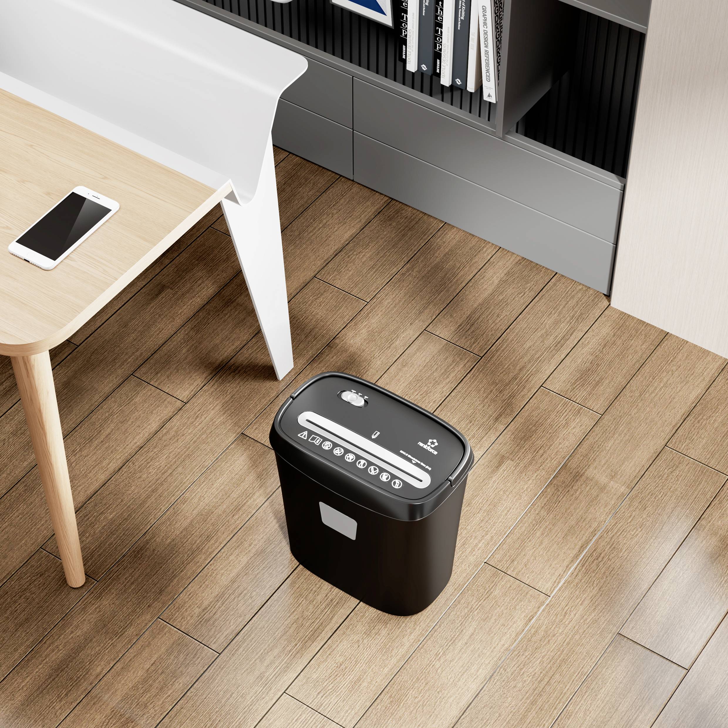 Een kantoor met een tafel waarop een smartphone ligt. Ernaast een papiervernietiger en een boekenrek. Houten vloer op de achtergrond.