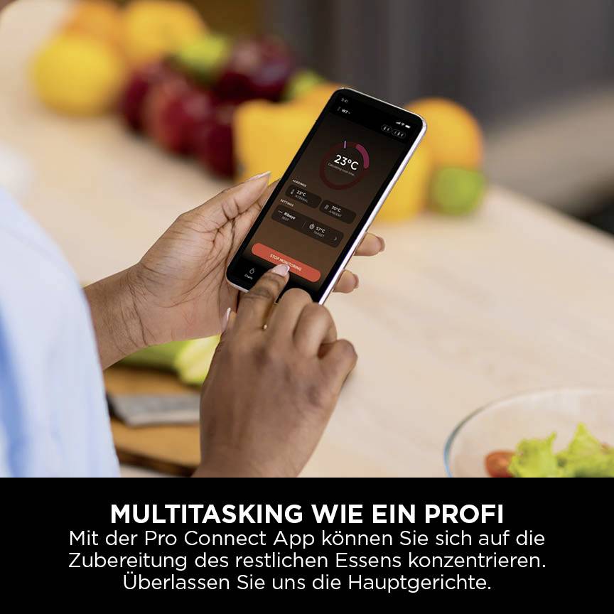 Een persoon houdt een smartphone vast waarop de temperatuur wordt weergegeven. Tekst eronder: 'Multitasken als een professional' met beschrijving van de app die helpt bij het koken.