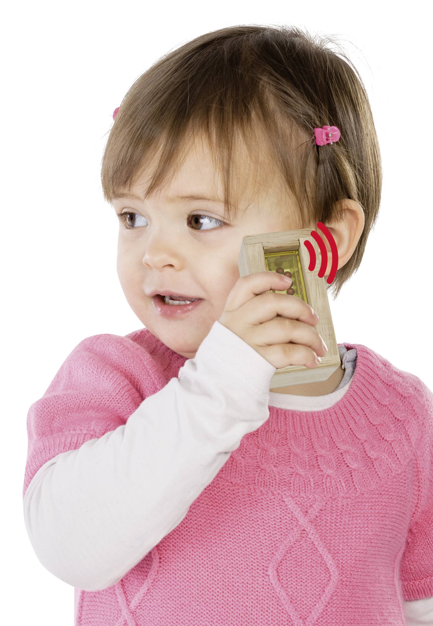 Een klein kind met een roze trui houdt een speelgoedtelefoon tegen zijn oor en doet alsof het aan het bellen is.