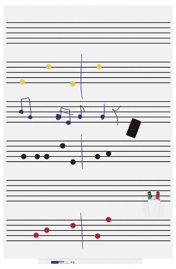 Muziekbord met notenbalkjes, waarop gekleurde magneten muzieknoten voorstellen; zwarte stiften en smartphone liggen ernaast.
