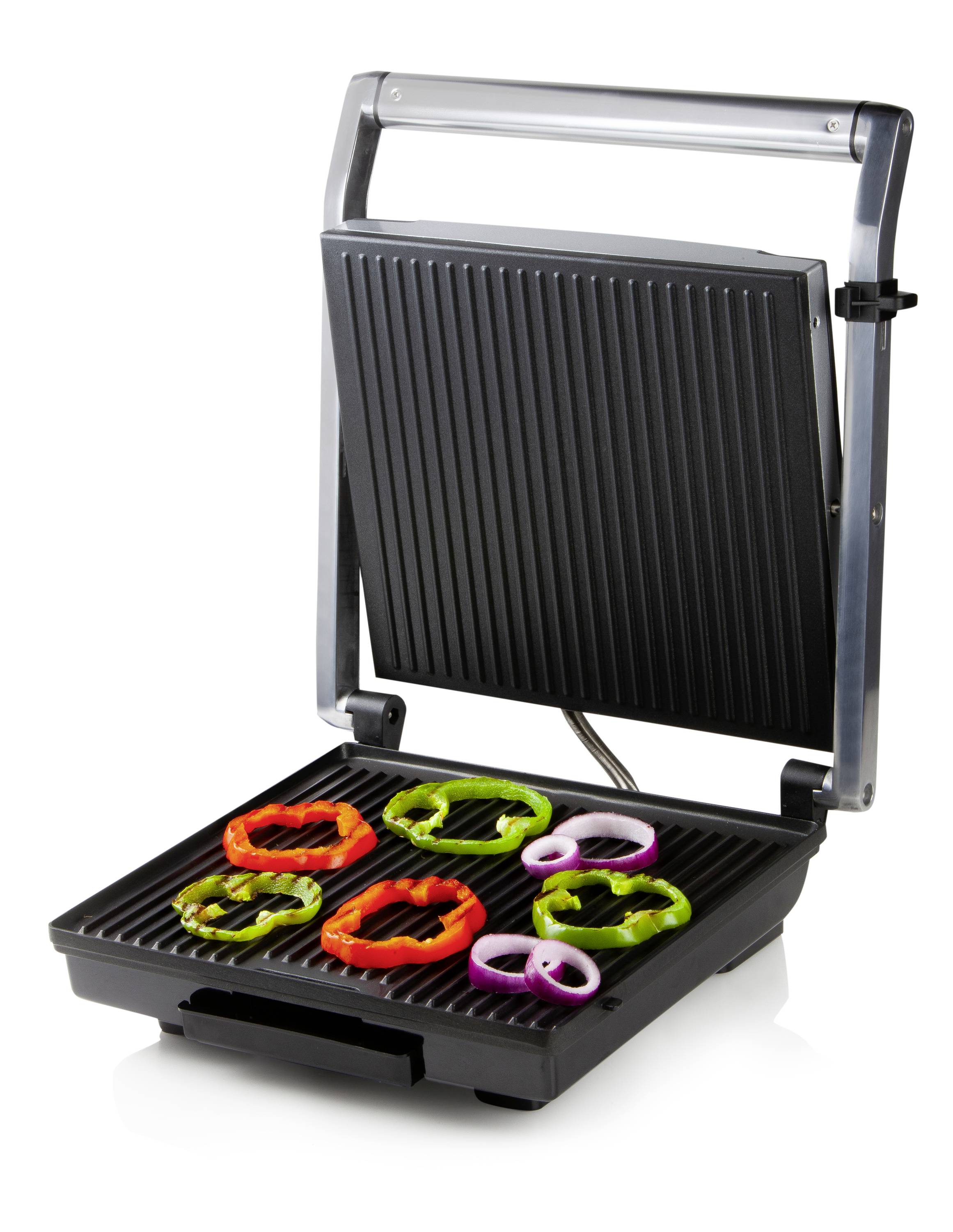 Een open contactgrill met gekleurde groente- en fruitringen op het grilloppervlak.