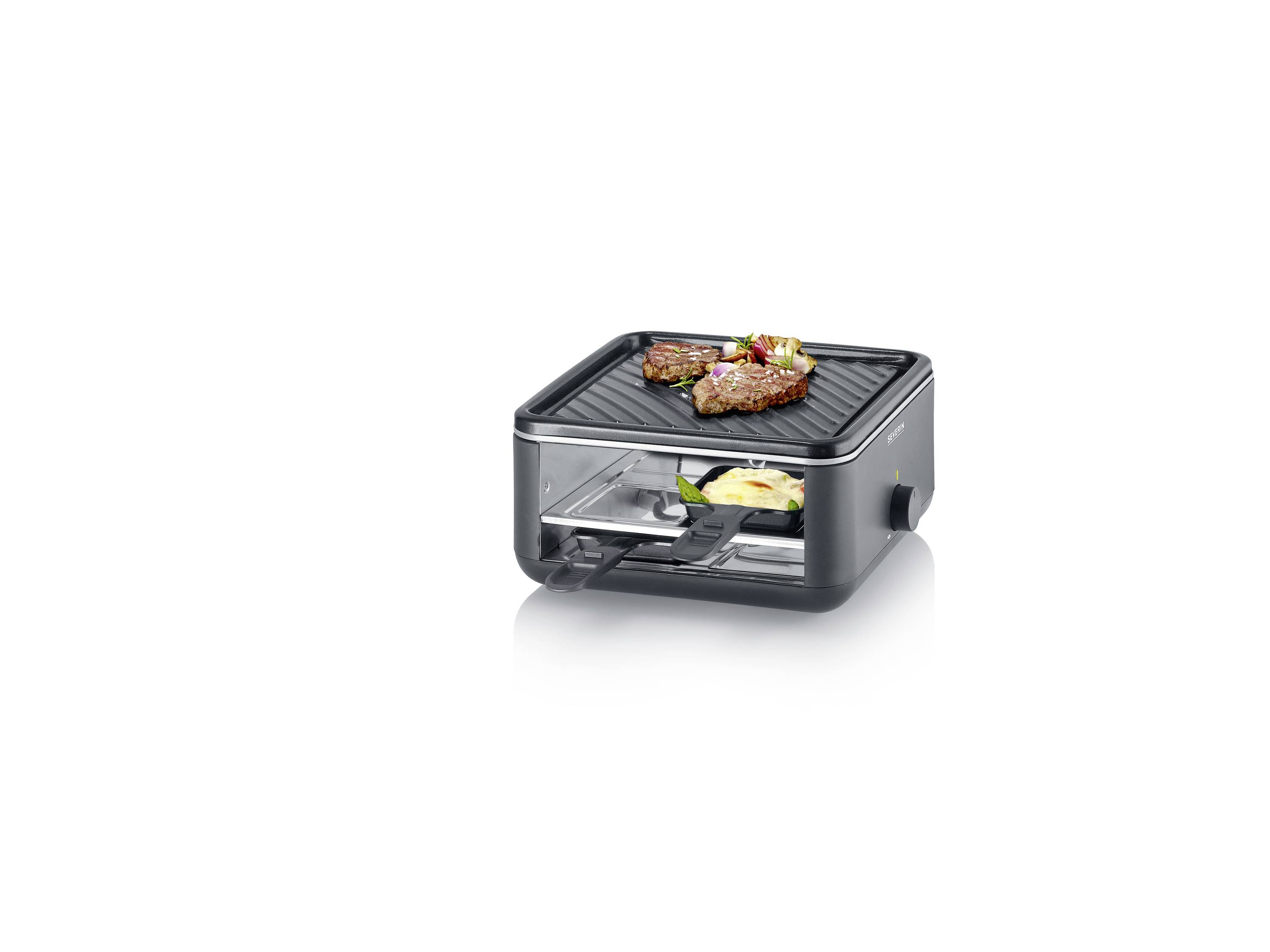 Een compacte contactgrill met twee stukken vlees bovenaan, daaronder een pan met groenten. Geschikt voor gelijktijdig grillen en koken.