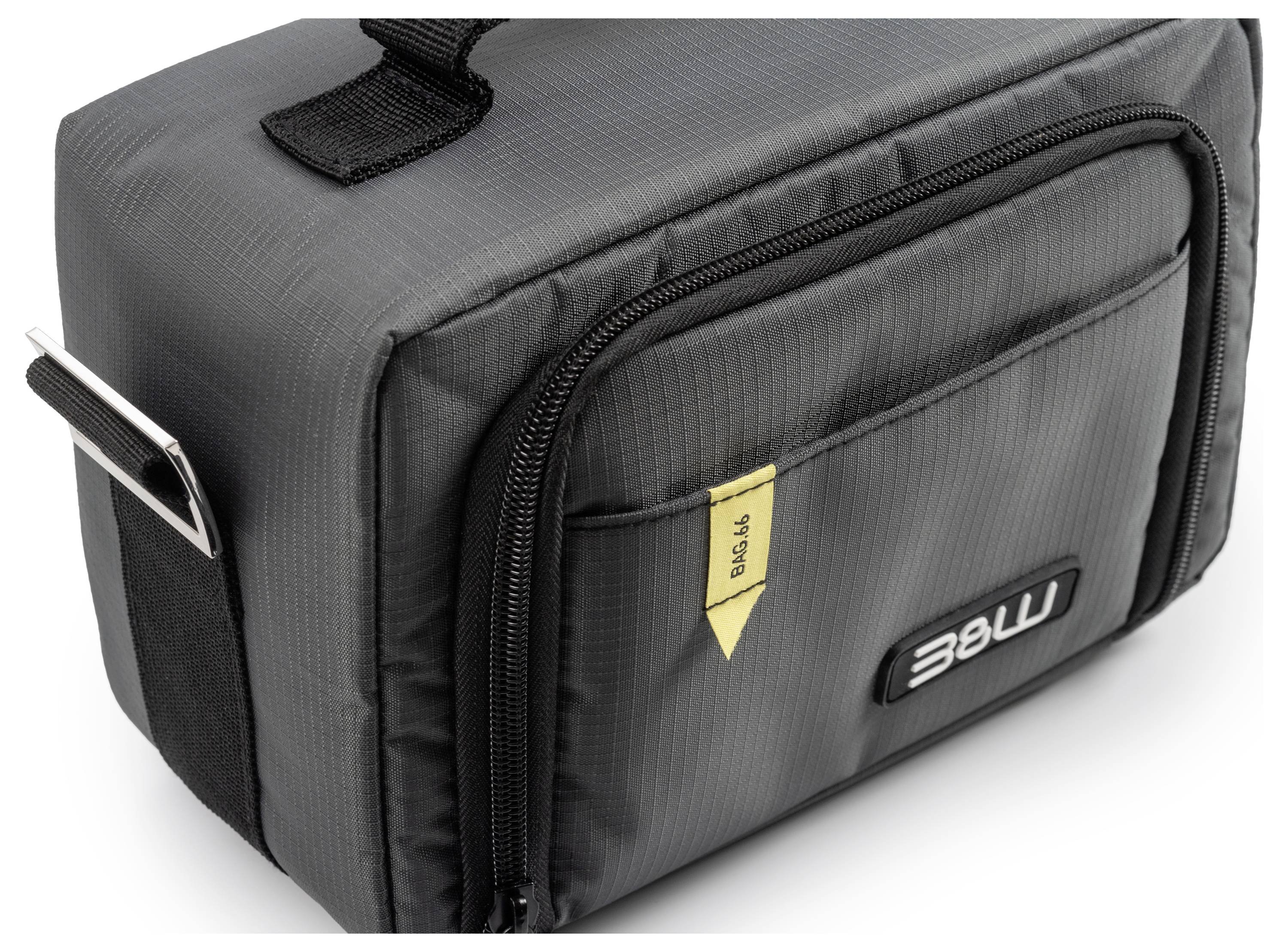 Zwarte, rechthoekige tas met handvat en voorvak met rits. Geel etiket met 'Blende' erop geschreven.