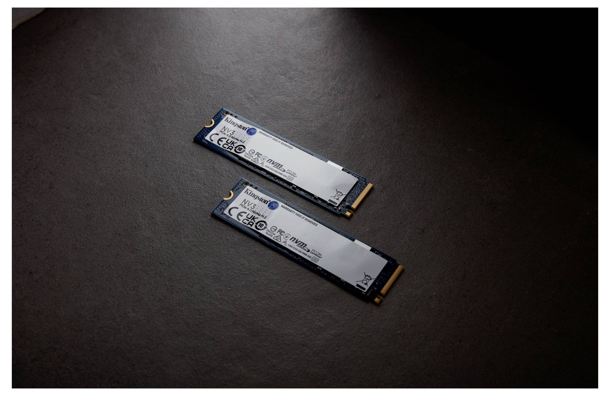 Twee M.2-SSD's liggen naast elkaar op een donkere ondergrond, waarbij hun aansluitingen en capaciteitsinformatie zichtbaar zijn.