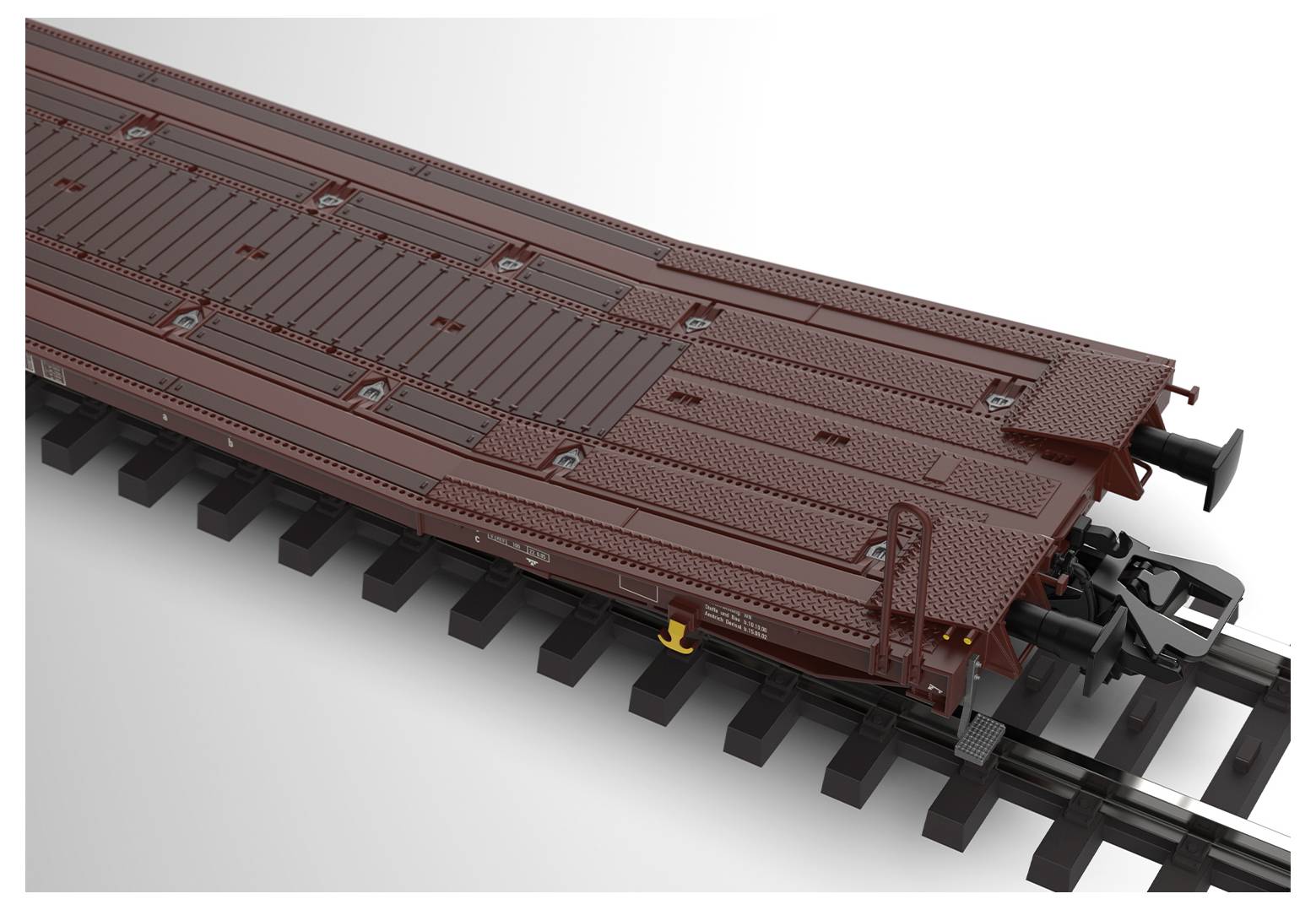 Een gedetailleerd model van een bruine goederenwagon op zwarte rails, waarbij voornamelijk het eind- en bovenstuk worden getoond.