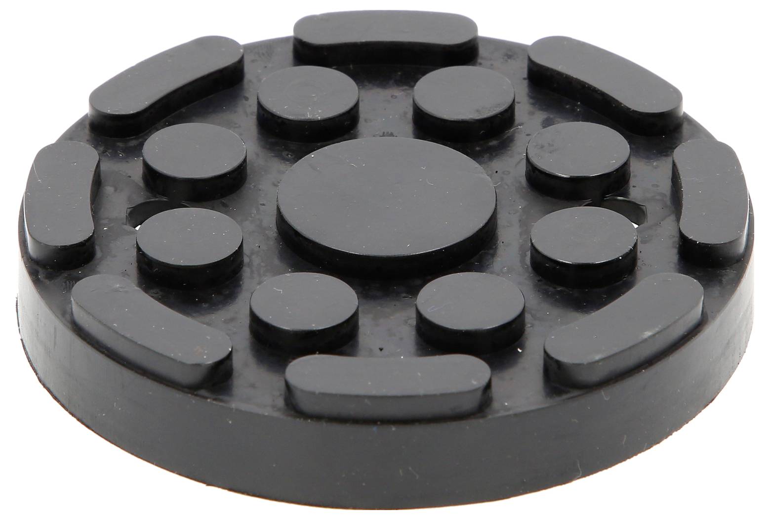Een ronde, zwarte rubberen voet met verhoogde cirkels en lijnen, gebruikt voor demping of stabilisatie van apparaten op oppervlakken.