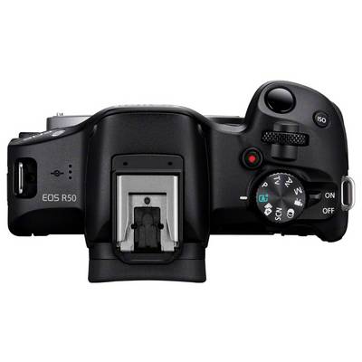 Digitale camera van bovenaf met moduskeuzeknop, sluiterknop en display.