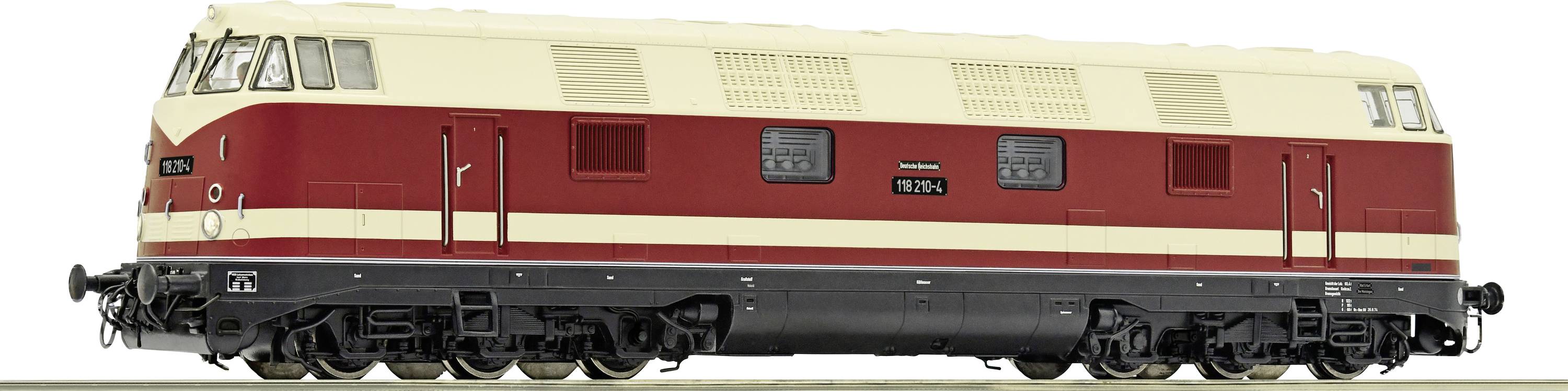 Modelspoorbaan: Een crème-rode diesellocomotief van de serie V 180 op een spoorsectie, met details van ramen en deuren.