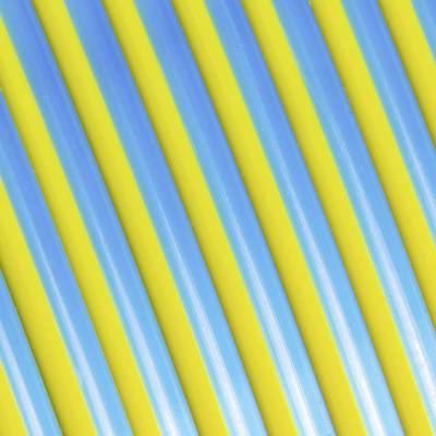 Close-up van kleurrijk gestreepte plastic rietjes in blauw en geel, die parallel lopen.