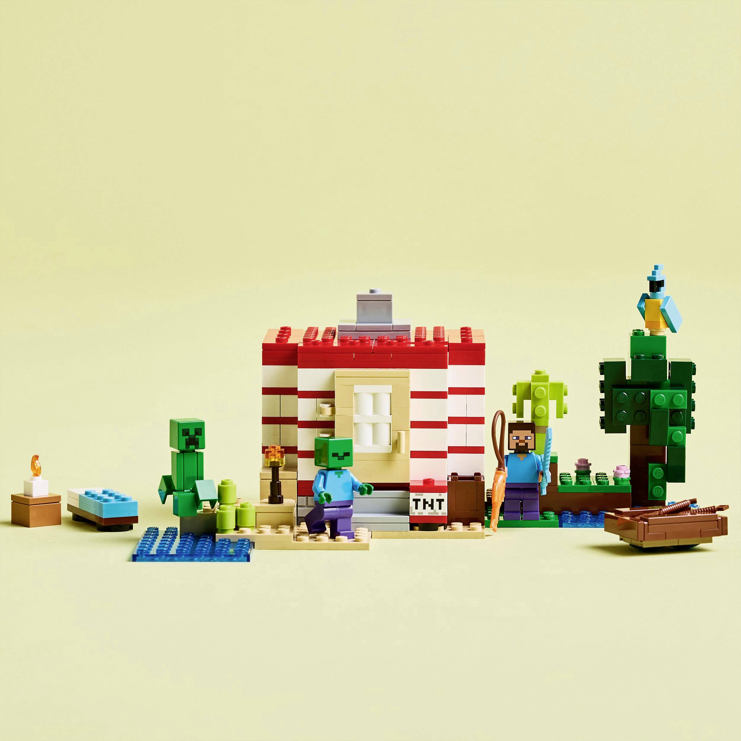 Een kleurrijke LEGO-scène met een Minecraft-huis, figuren en bomen, die een spelsituatie uit het videospel Minecraft weergeeft.