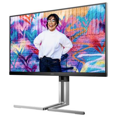 Een monitor toont een afbeelding van een lachende persoon voor een kleurrijke, grafische wand met levendige kleuren en patronen.