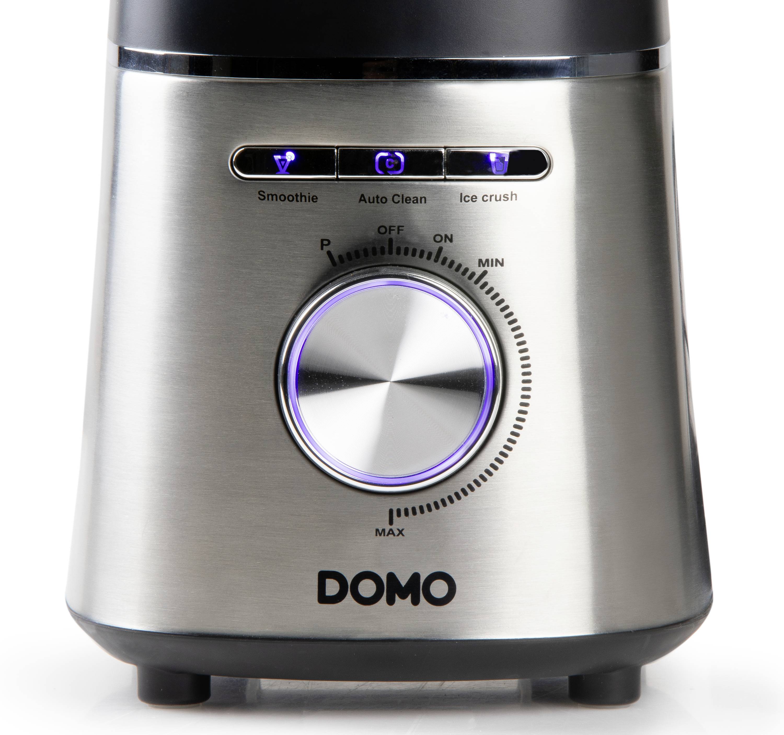 Een zilveren mixer van het merk Domo met een grote draaiknop en drie blauwe LED-indicatoren voor 'Smoothie', 'Auto Clean' en 'Ice Crush'.