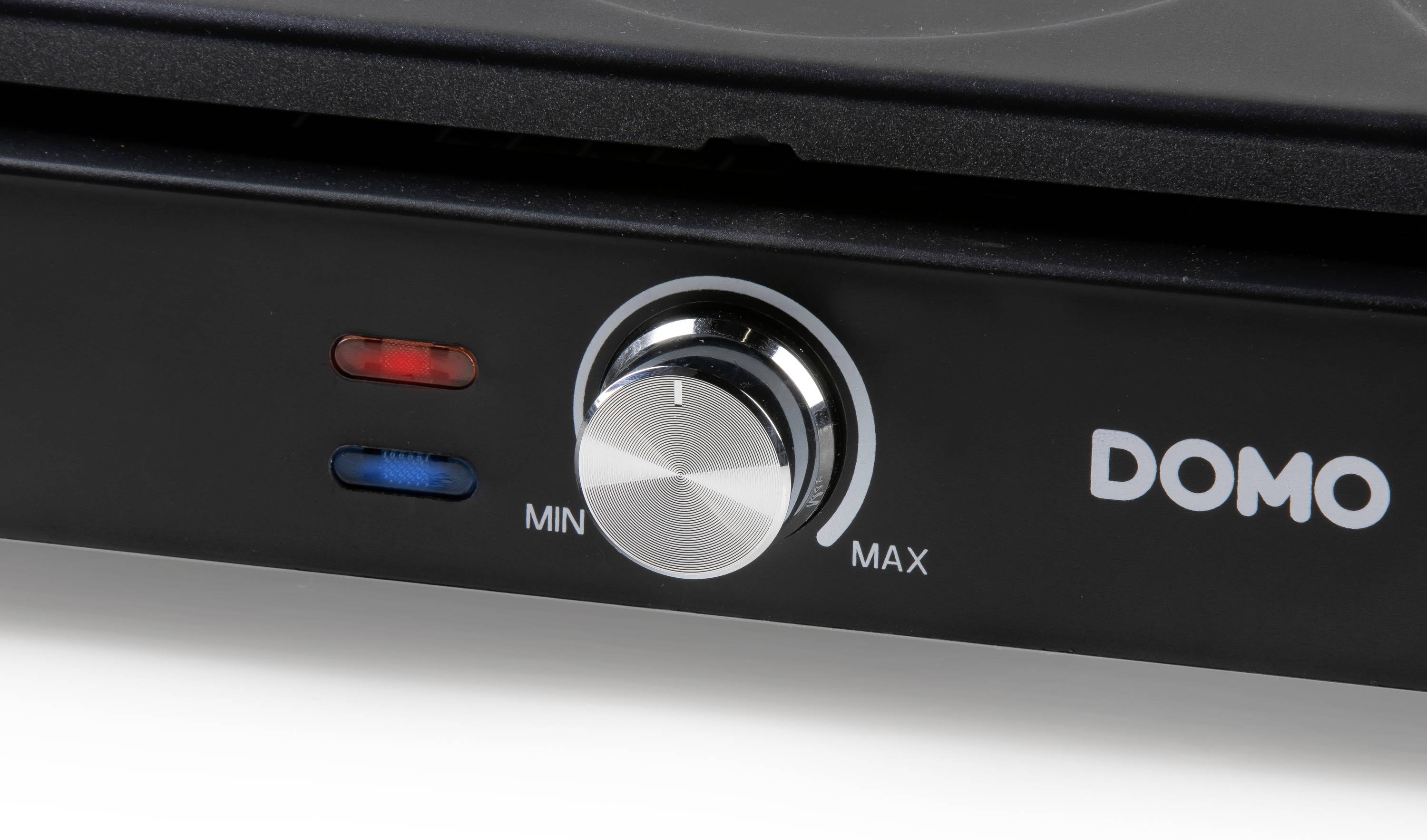 Een close-up van een zwarte draaiknop op een elektrisch apparaat met de markeringen 'MIN' en 'MAX' en twee indicatorlampjes.