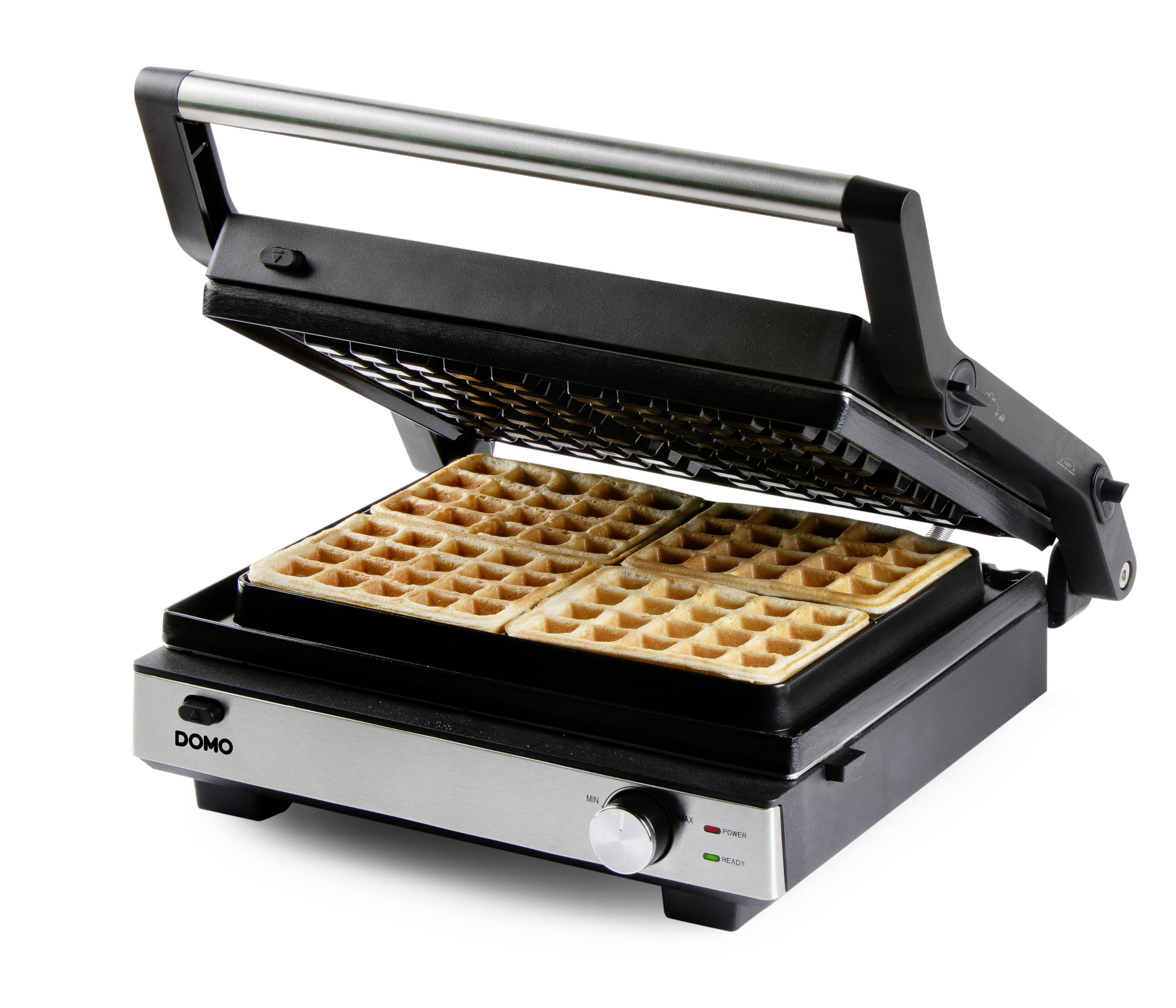 Een elektrische wafelijzer met opengeslagen deksel toont afgewerkte rechthoekige wafels. De indicatielampjes zijn groen en rood.