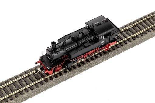 Stoomlocomotief op schaal op een kort stuk spoor, met gedetailleerd zwart en rood ontwerp, gezien van bovenaf.
