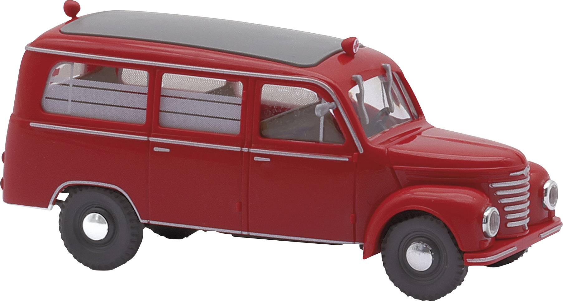 Een rood, vintage speelgoedautootje in het model van een klassieke bestelwagen met twee zijramen en een zwart dak.