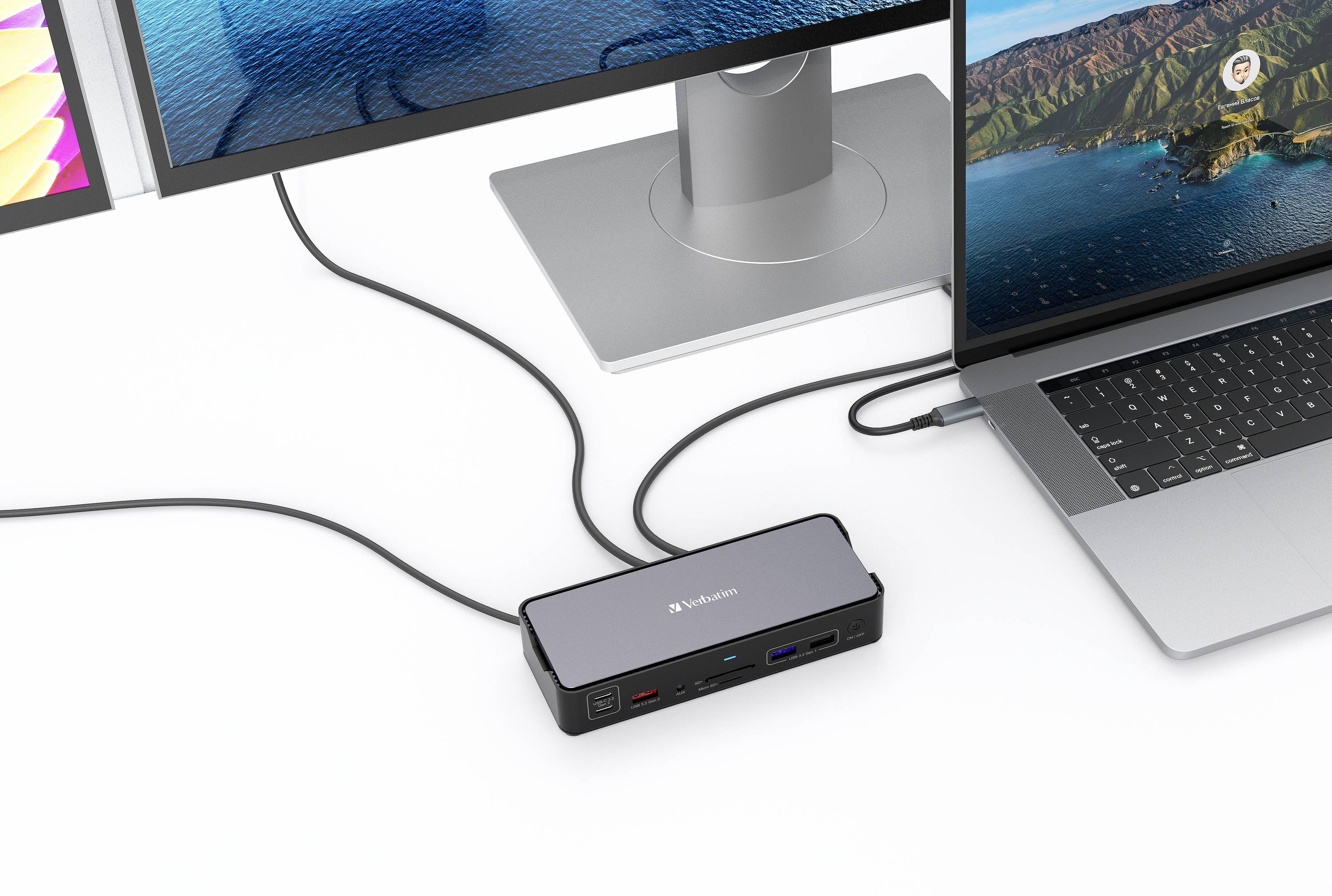 Een laptop is verbonden met twee monitoren via een Verbatim USB-C-dock, waarop verschillende schermen worden weergegeven.