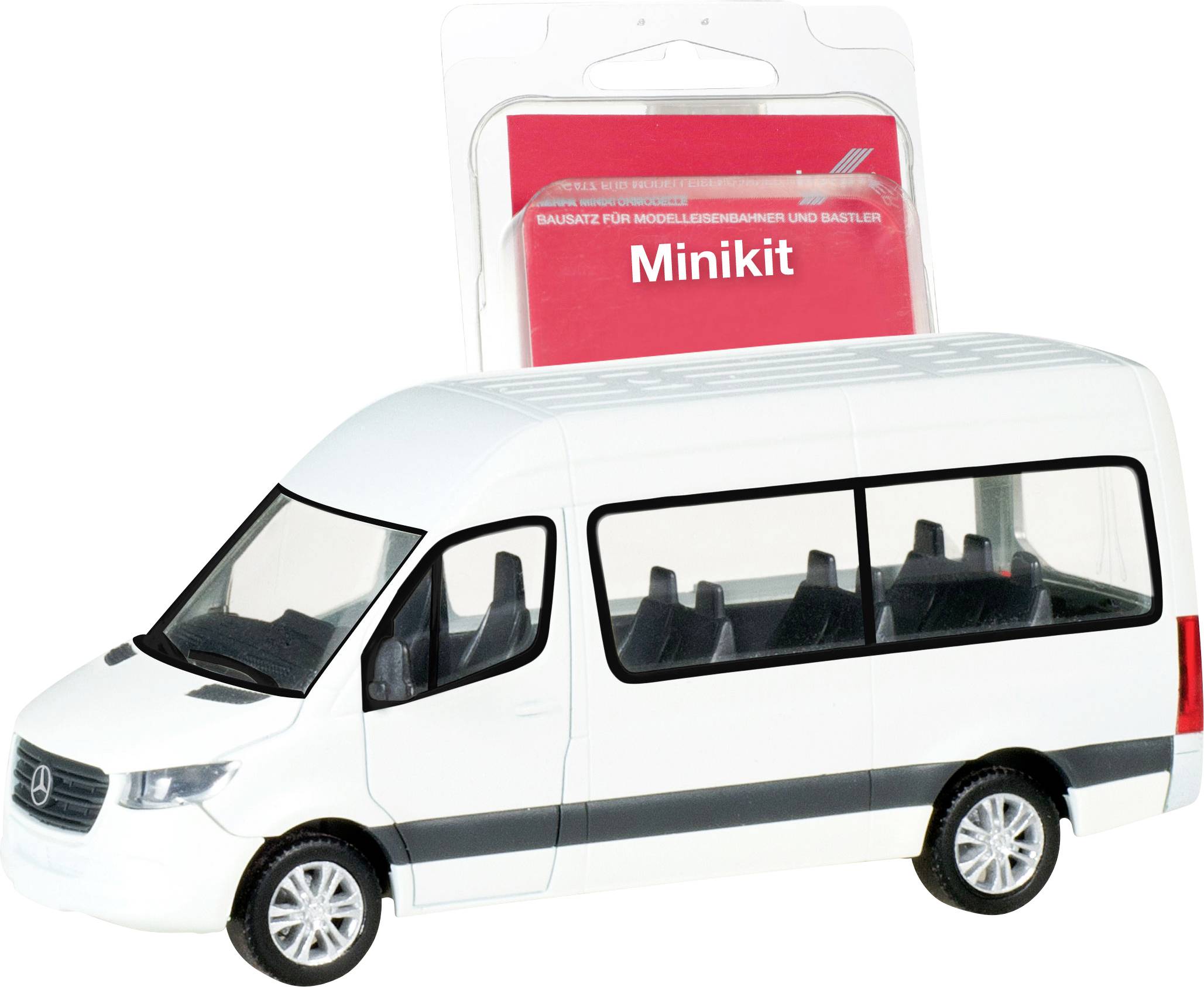Een miniatuurmodel van een witte bestelwagen voor een verpakking met het opschrift 'Minikit'. De bus heeft zwarte ramen en wielen.
