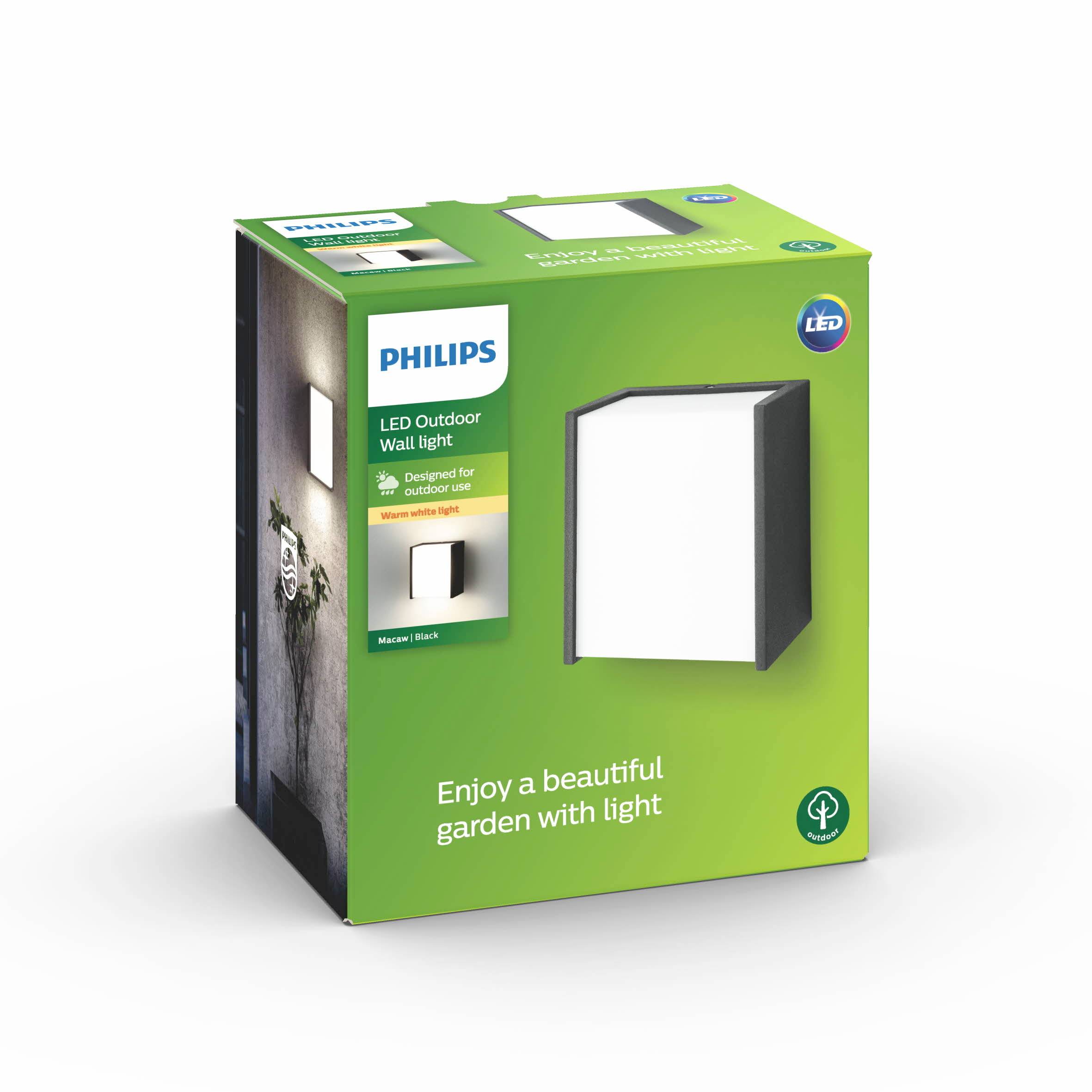Verpakking van een Philips LED-buitenwandlamp in zwart, geschikt voor buitengebruik. Afgebeelde verlichte lamp aan een muur. Slogan: "Geniet van een prachtige tuin met licht".