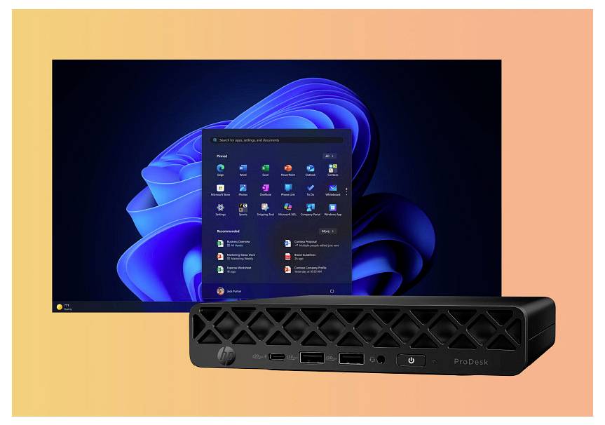 Een desktopcomputer met Windows 11, waarop een startscherm met een lijst van applicaties wordt weergegeven. Een zwarte computertoren is zichtbaar op de voorgrond.