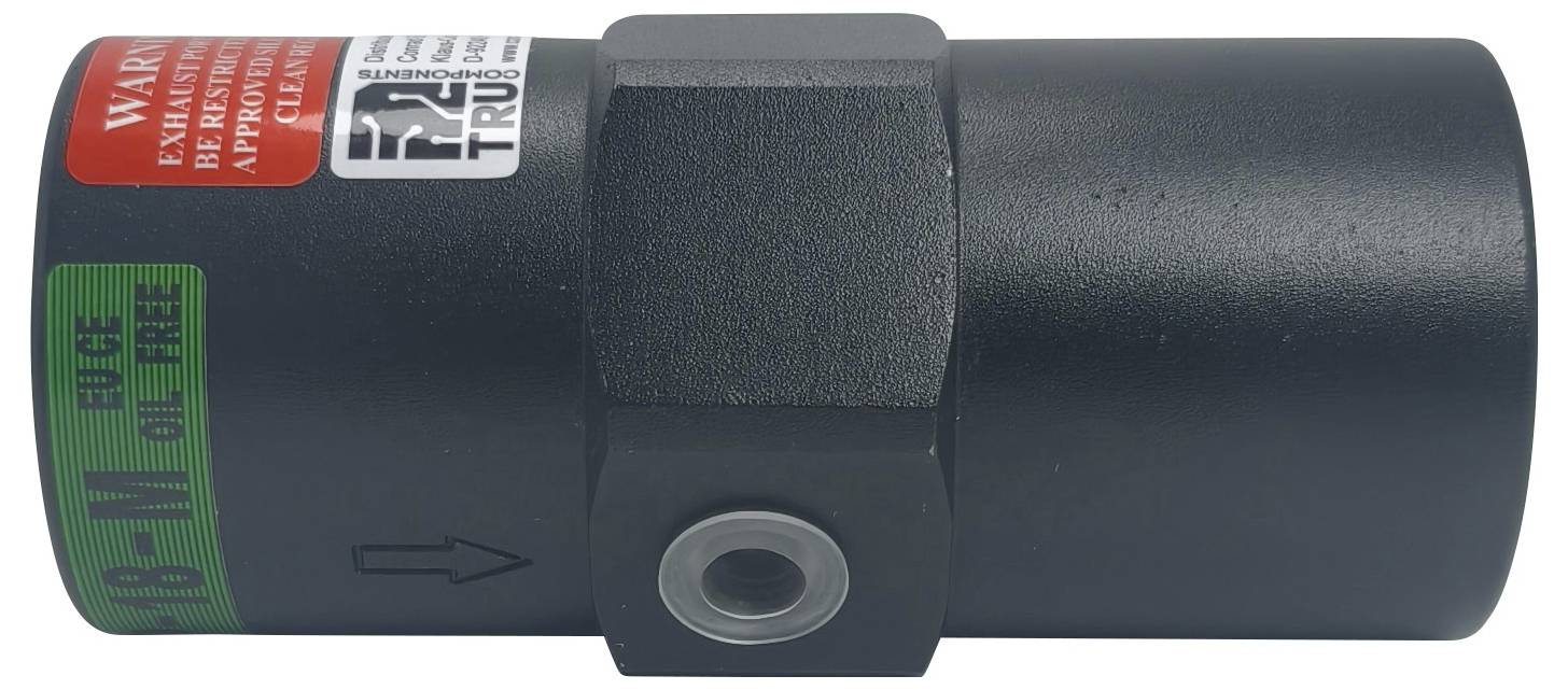 Een zwarte cilindrische mechanische component met een zeshoekig midden en rode en groene waarschuwingslabels.