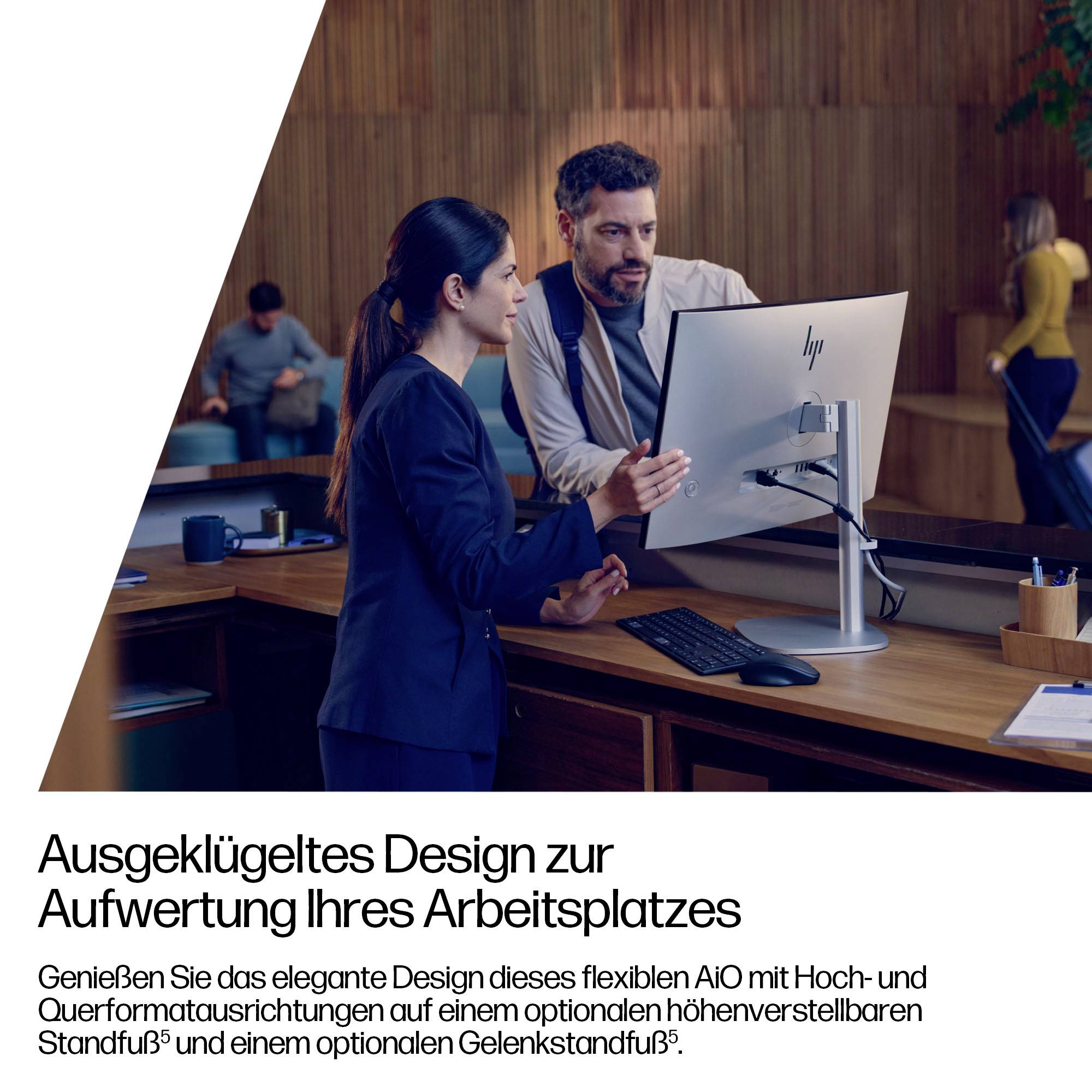 Een vrouw en een man bespreken werk in een kantooromgeving bij een desktopcomputer. Tekst in het Duits promoot een flexibel, elegant werkstationontwerp.