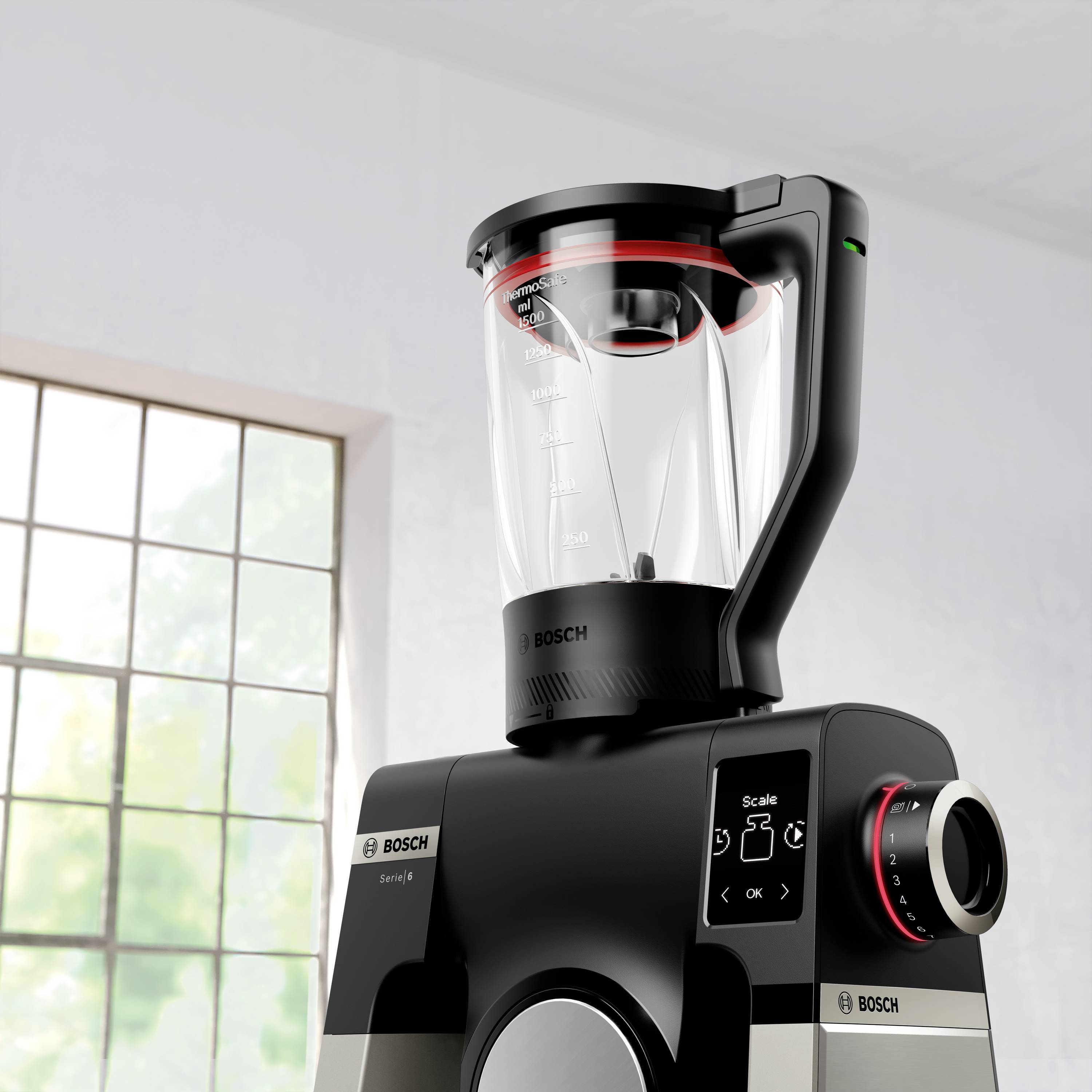 Een moderne zwarte en zilveren blender met een transparante kan op een aanrecht in de buurt van een raam, voorzien van digitale bediening en een strak design.