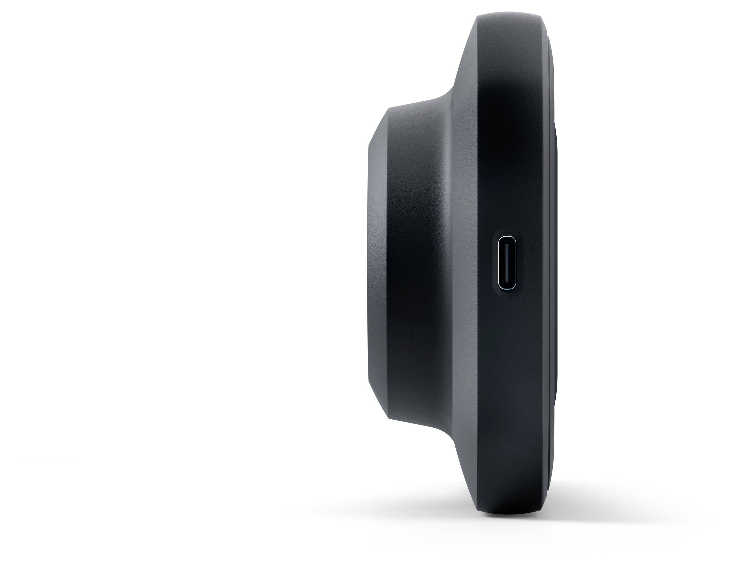 Zijaanzicht van een zwart, rond elektronisch apparaat met een USB-C-poort, dat een compacte en minimalistische vormgeving laat zien.