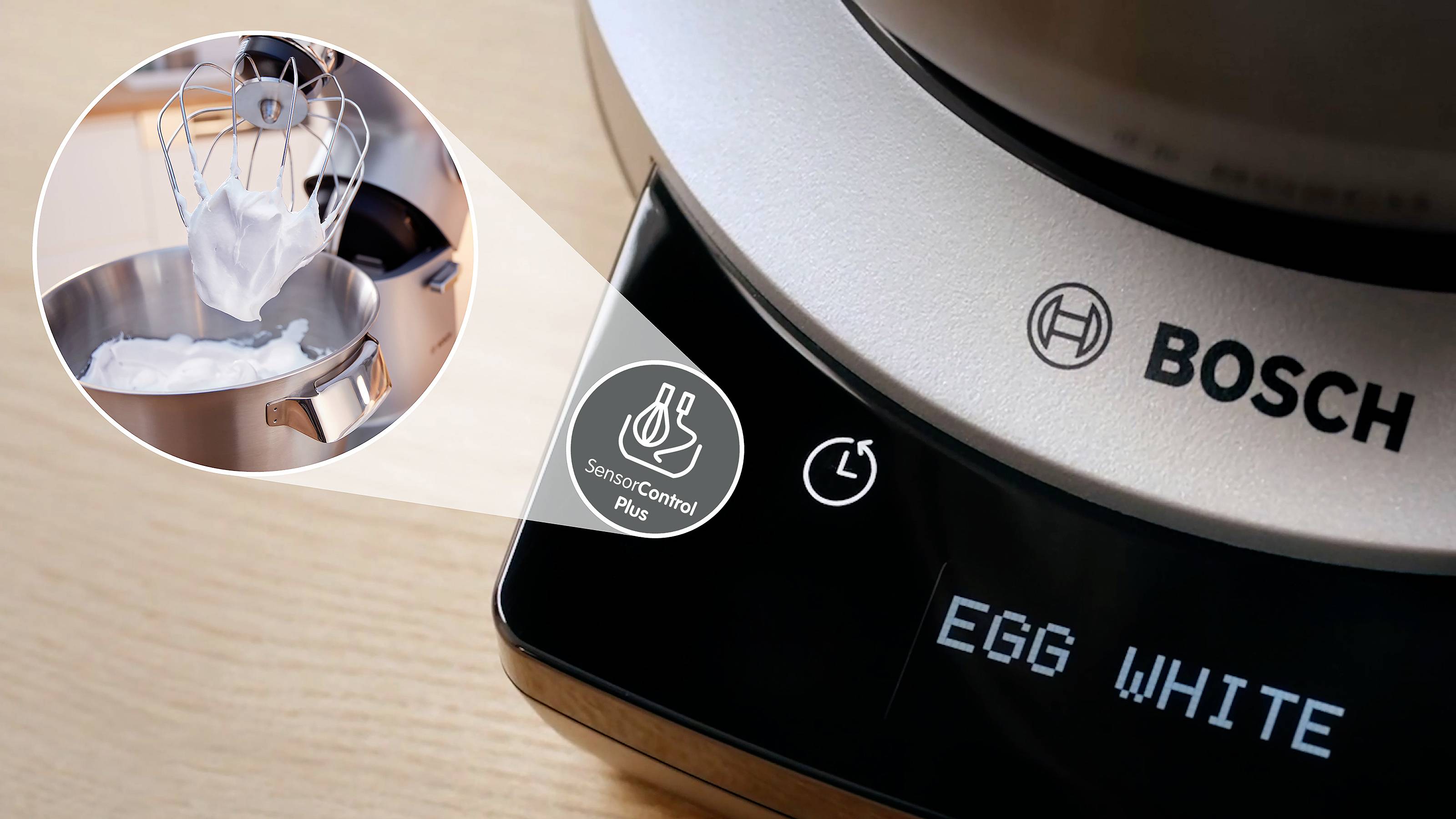 Een close-up van een Bosch-mixerdisplay waarop 'EGG WHITE' staat en een rond ingezet beeld van het kloppen van eiwitten in een kom.