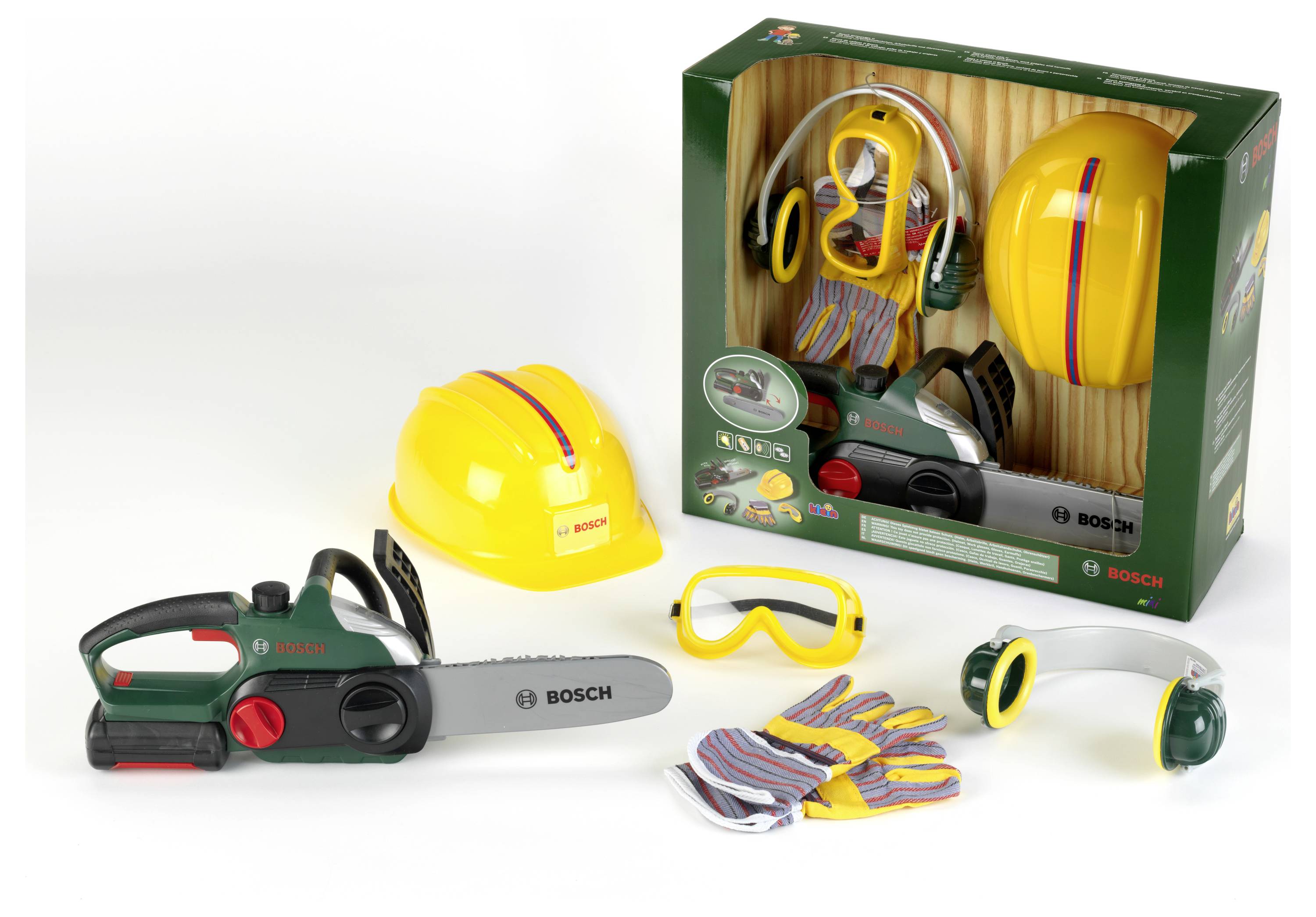 Constructiespeelgoed met een gele helm, kettingzaag, veiligheidsbril, handschoenen en gehoorbescherming. Verpakt in een groene doos met zichtbaar merklogo.
