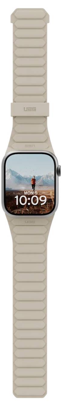Een smartwatch met een beige band toont een scherm waarop '10:09' uur staat en een achtergrondafbeelding van een persoon die in een woestijnlandschap staat.