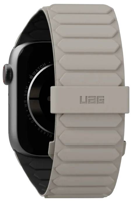 Een smartwatch met een beige, robuuste riem met een gesp waarop de tekst 'UAG' staat, weergegeven in een close-up zijaanzicht.