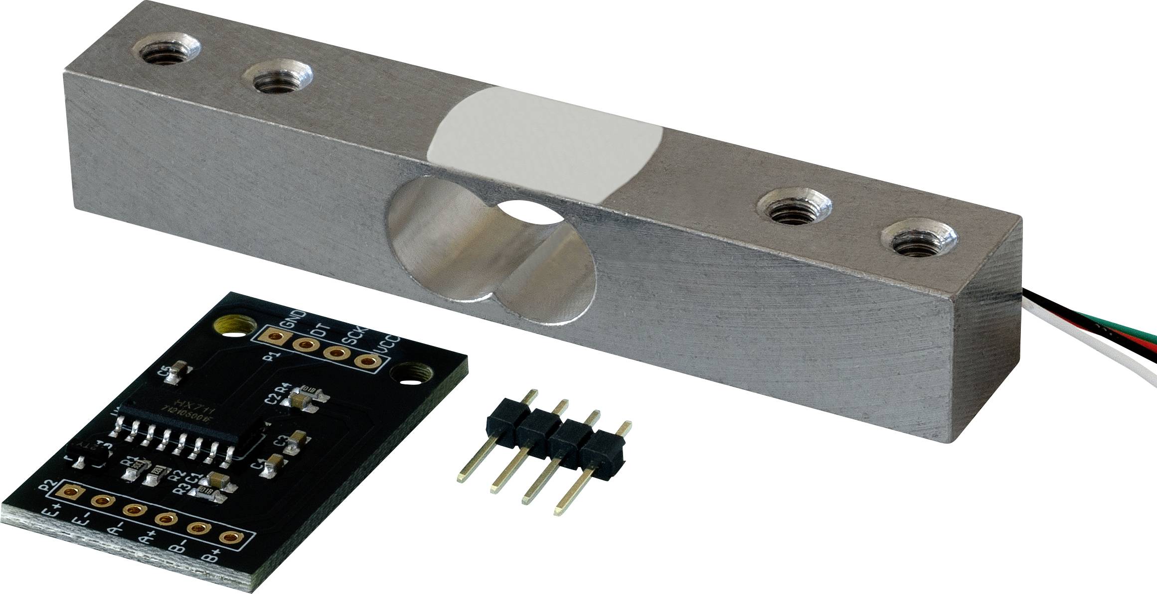 Een metalen belastingscel sensor met draden naast een kleine elektronische printplaat, gebruikt voor gewichtsmetingen in industriële toepassingen.