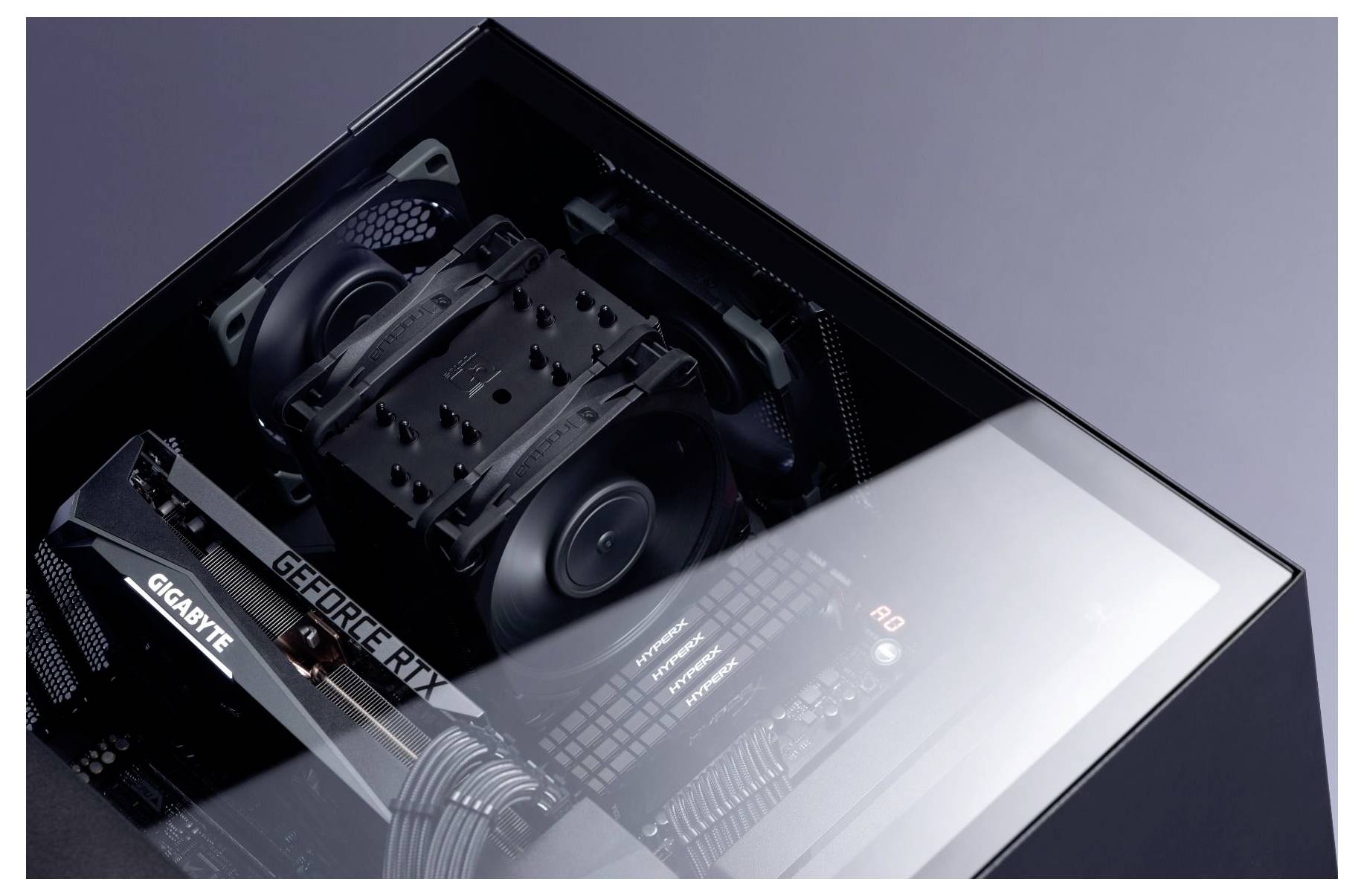 Interne componenten van een computer, met GPU gelabeld als 'GIGABYTE' en 'GEFORCE RTX', koelventilatoren en moederbord in een reflecterende behuizing.