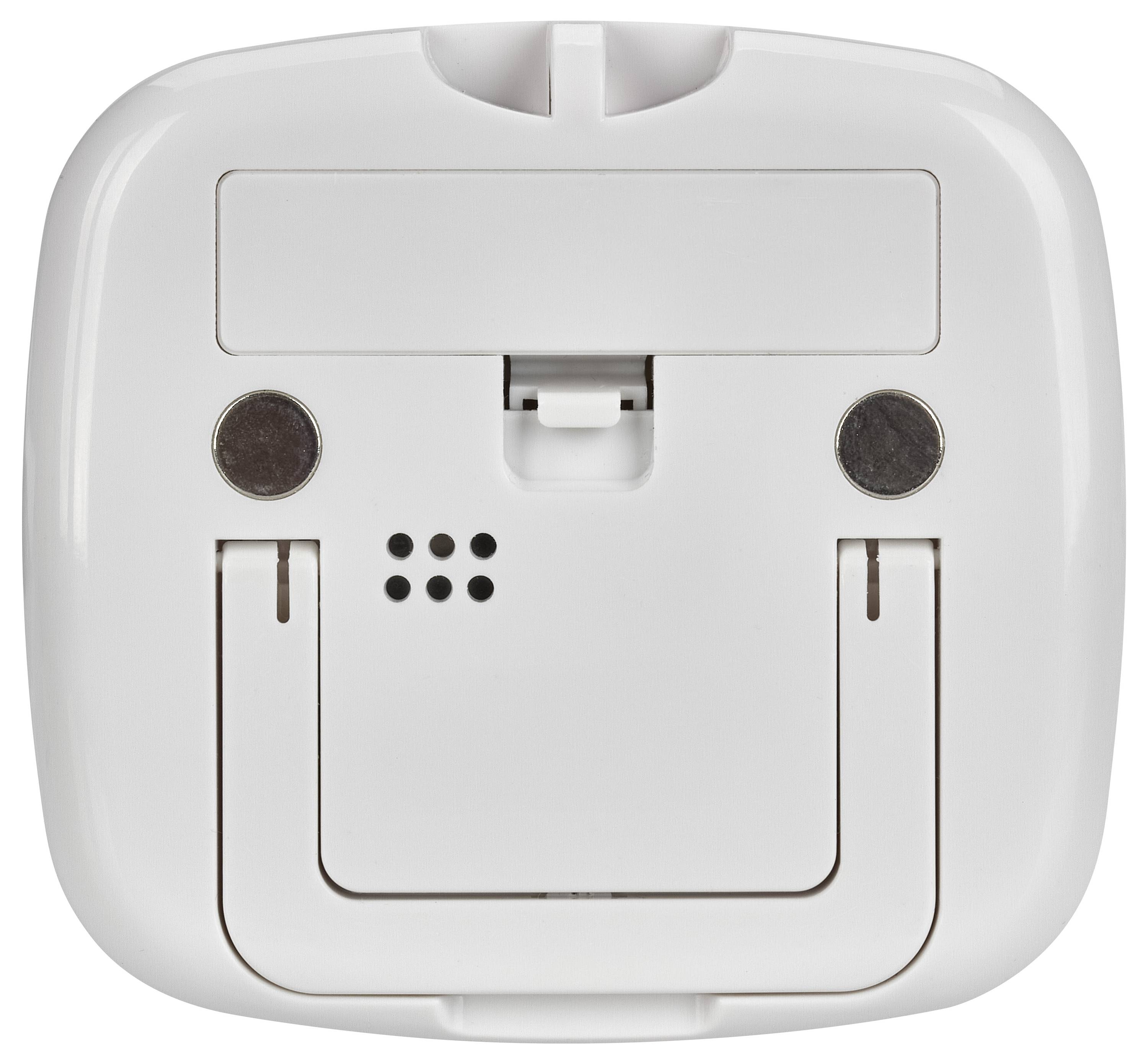 De afbeelding toont de onderkant van een wit elektronisch apparaat met een rechthoekige klep, twee ronde contactpunten en een set ventilatieopeningen.