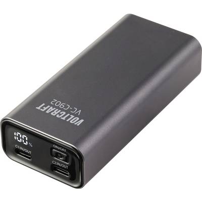 Een zwarte, rechthoekige powerbank met twee USB-C-poorten met de labels 'C1-IN/OUT' en 'C2-IN/OUT'. Het scherm toont het laadniveau '100%'.