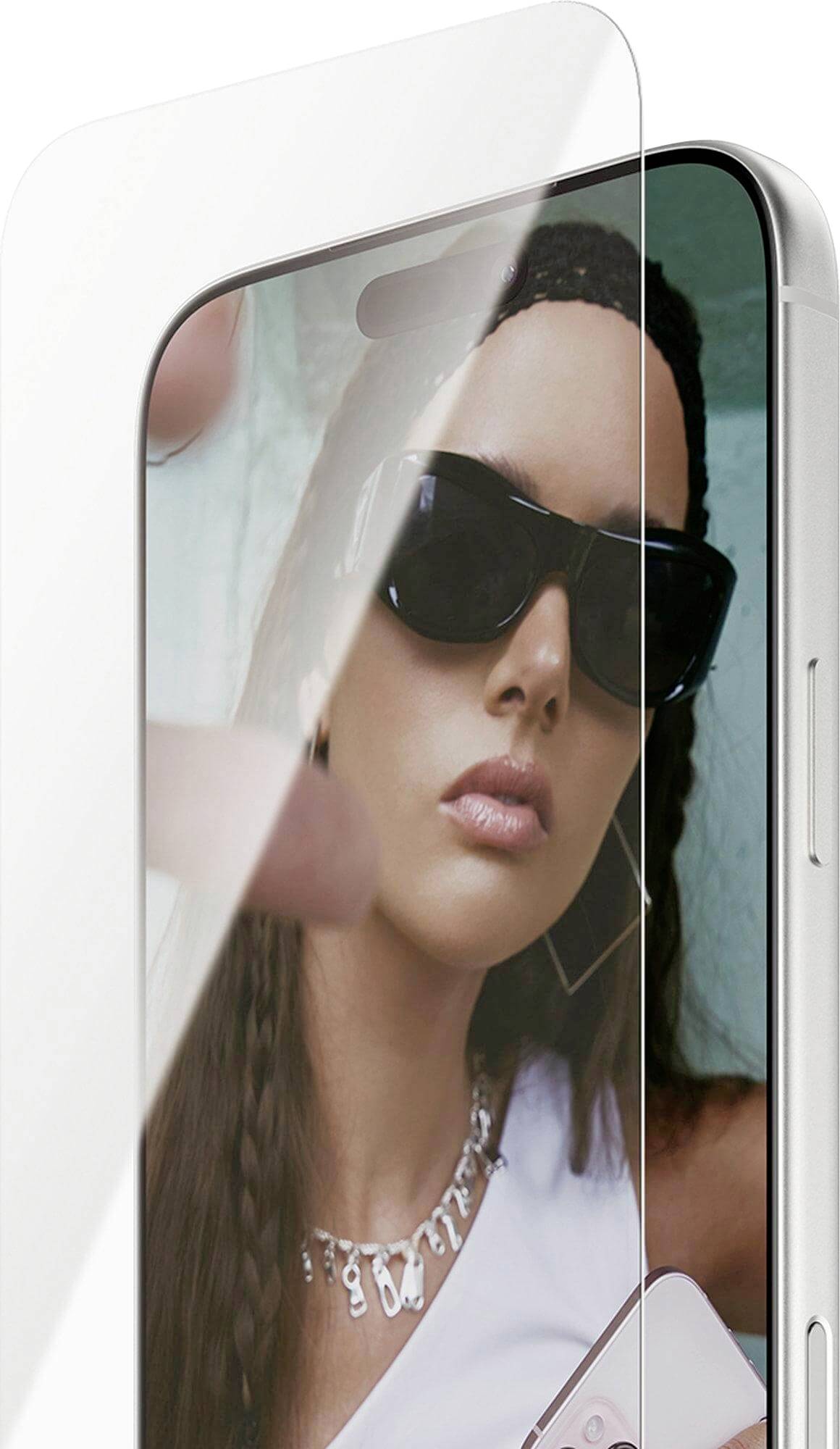 Een persoon met zonnebril wordt weerspiegeld op het scherm van een smartphone met een doorzichtige screenprotector die gedeeltelijk is aangebracht.