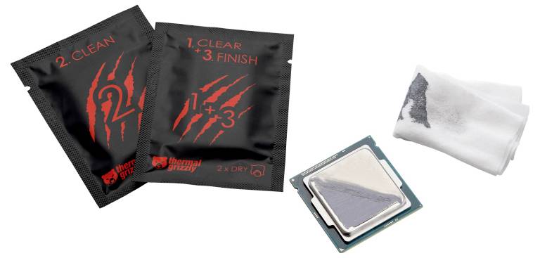 'Twee reinigingsdoekjes gemerkt als 2 Clean, 1 Clear & Finish naast een verpakte zilveren CPU. Deze zijn bedoeld voor het reinigen en voorbereiden van het CPU-oppervlak.'