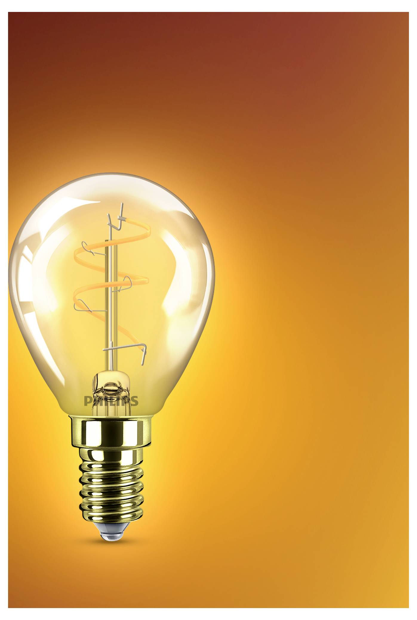Een brandende Edison-stijl gloeilamp met zichtbare gloeidraad schijnt tegen een oranje achtergrond, die een idee of innovatieconcept symboliseert.