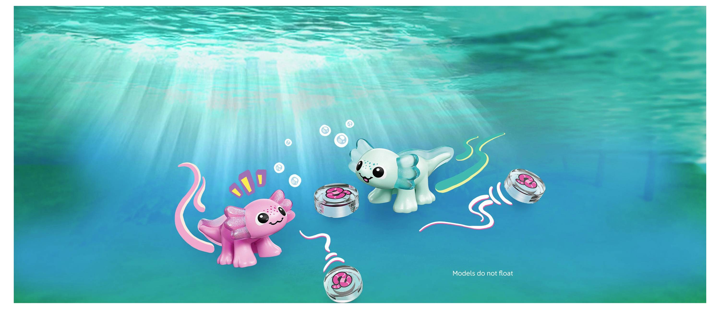 Twee kleurrijke speelgoed-creaturen met expressieve gezichten bevinden zich onder water, terwijl ze omgaan met kleine ronde objecten, te midden van lichtstralen.