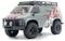 Een grijze 4x4 terreinwagen met rode en witte stickers, uitgerust met grote banden en een dakdrager, schuin naar links gepositioneerd om zijn robuuste ontwerp te benadrukken.