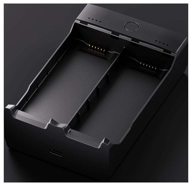 Een zwarte dubbele batterijlader met zichtbare oplaadsleuven en aansluitpennen. Geschikt voor het gelijktijdig opladen van twee batterijen.