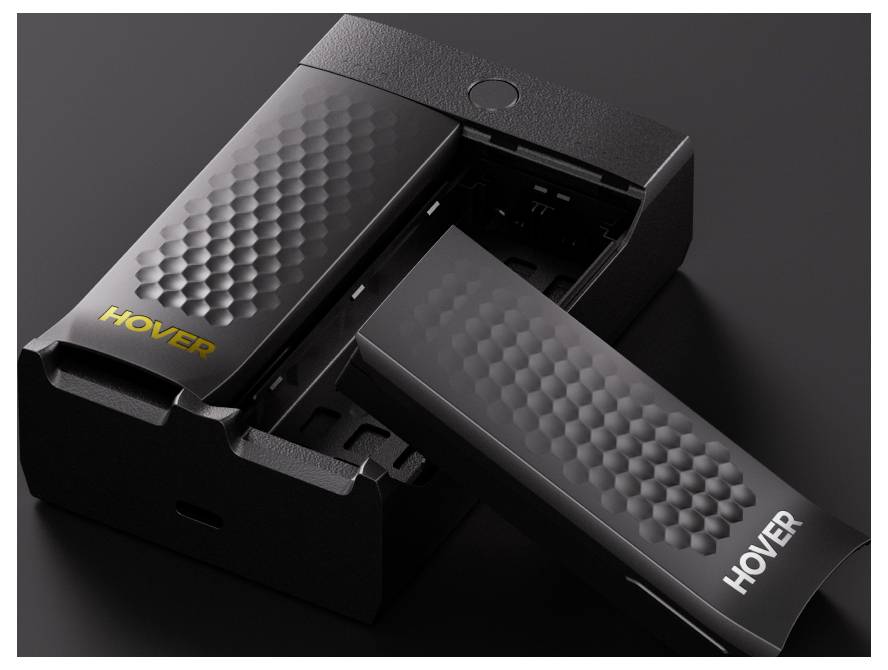Close-up van een futuristische zwarte apparaat met een gestructureerd oppervlak, voorzien van het label 'HOVER'. Een compartiment is geopend, waardoor een intern onderdeel zichtbaar wordt.