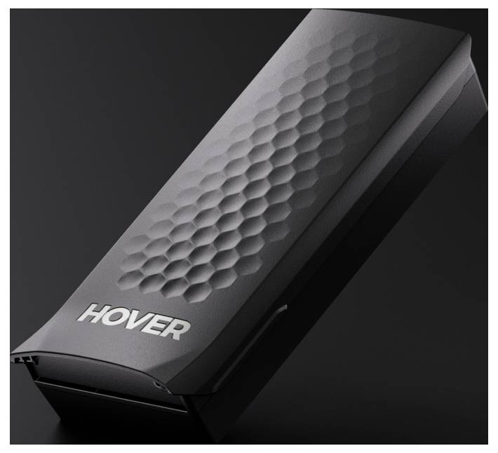 Een strak, zwart apparaat met het label 'HOVER', voorzien van een gestructureerd zeshoekig patroon op zijn oppervlak, geplaatst tegen een donkere achtergrond.