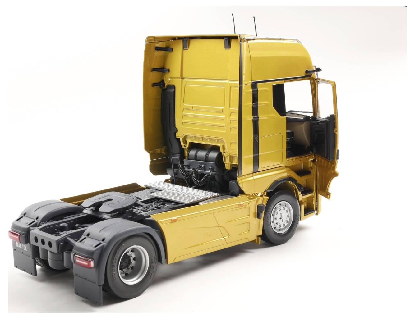 Een geel en zwart semi-truck model wordt getoond zonder aanhanger. De focus is op de cabine van de truck en het achterste chassis, waarbij de details worden benadrukt.