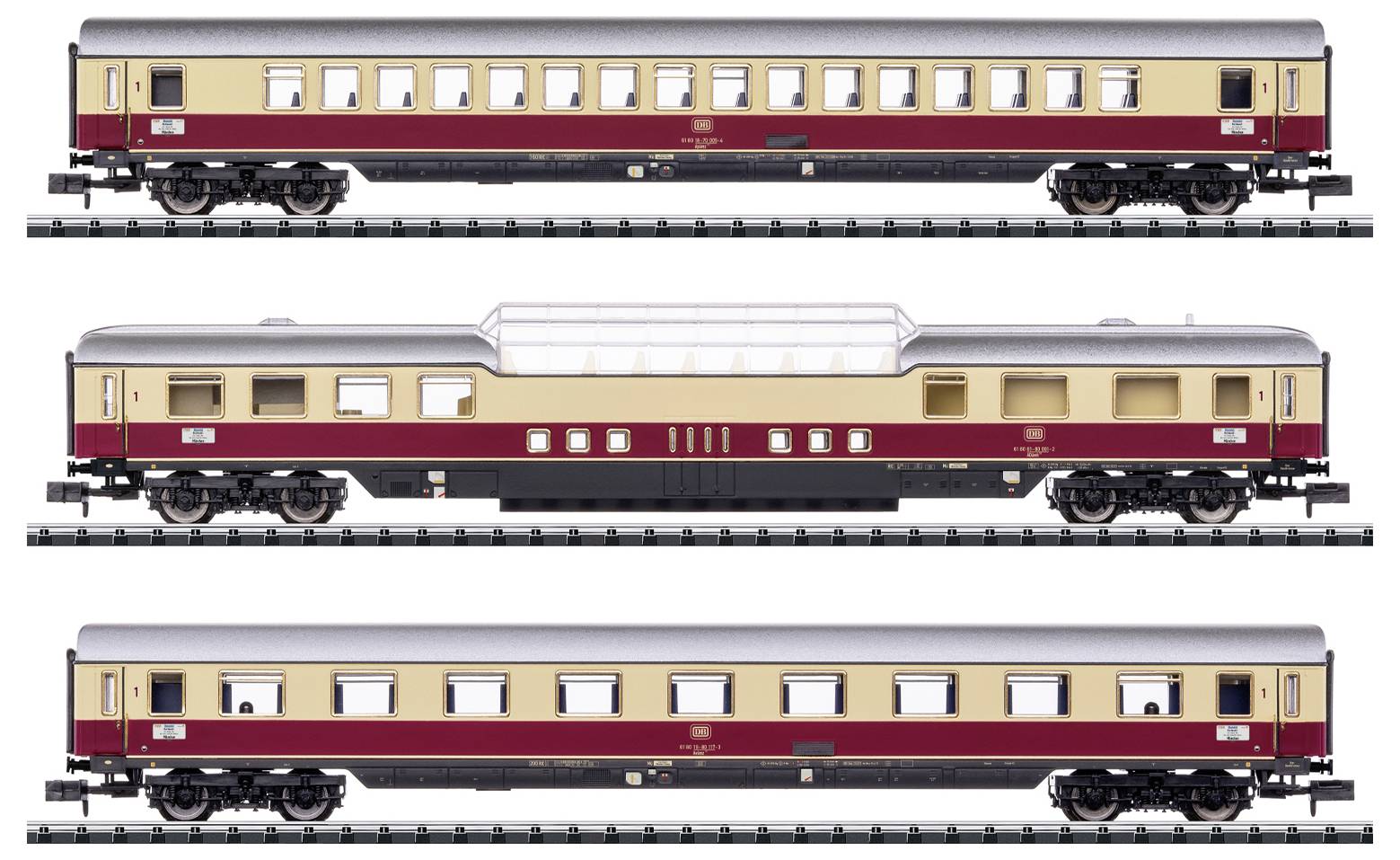 Drie modeltreinpassagierswagens in crème en donkerrood, gezien van opzij op afzonderlijke rails. De middelste wagen heeft een transparante dakconstructie.